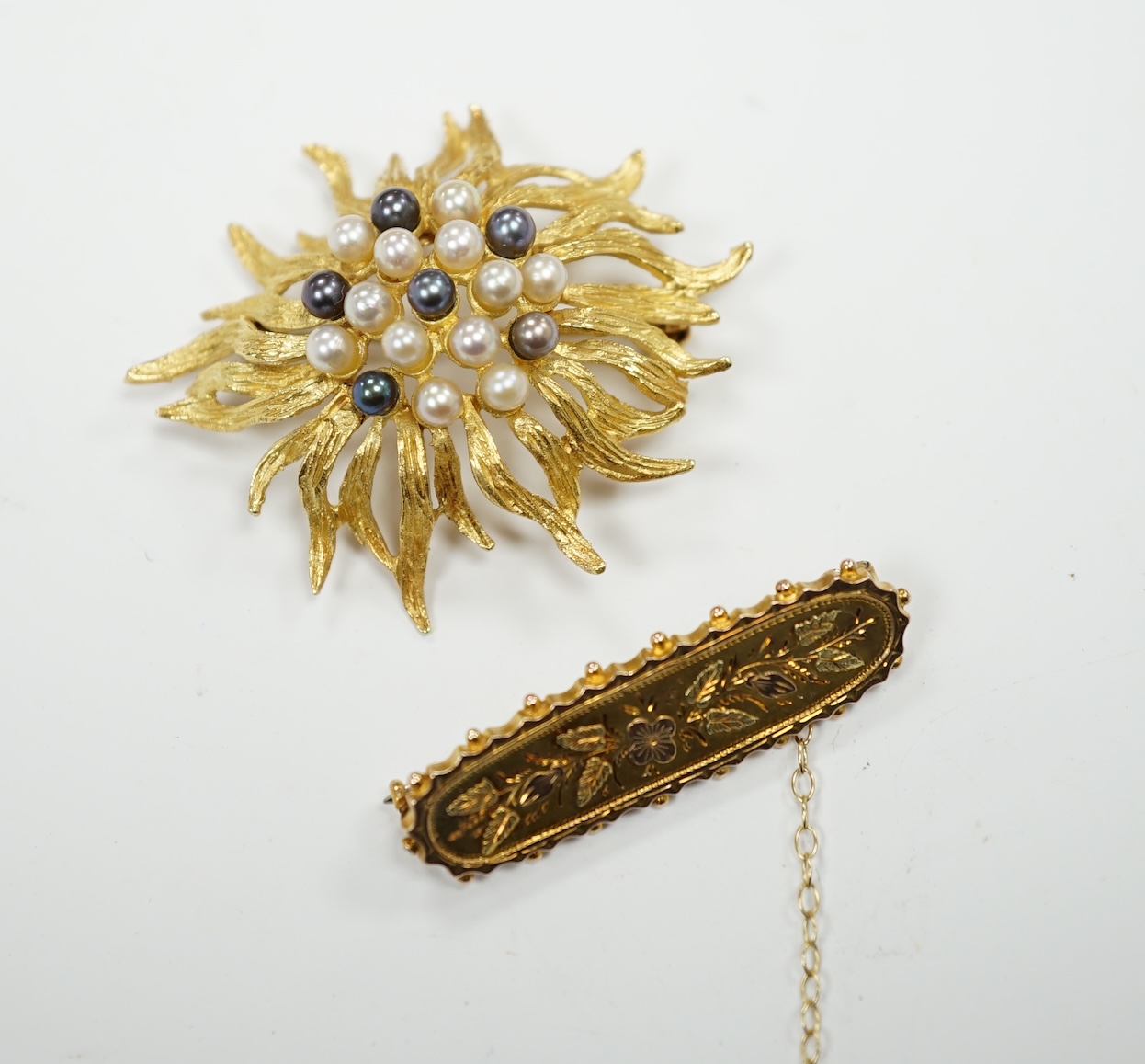 A continental 750 yellow metal and cultured pearl cluster set brooch, 44mm, gross weight 11.5 grams, together with a late Victorian three colour gold bar brooch, gross 2.4 grams.